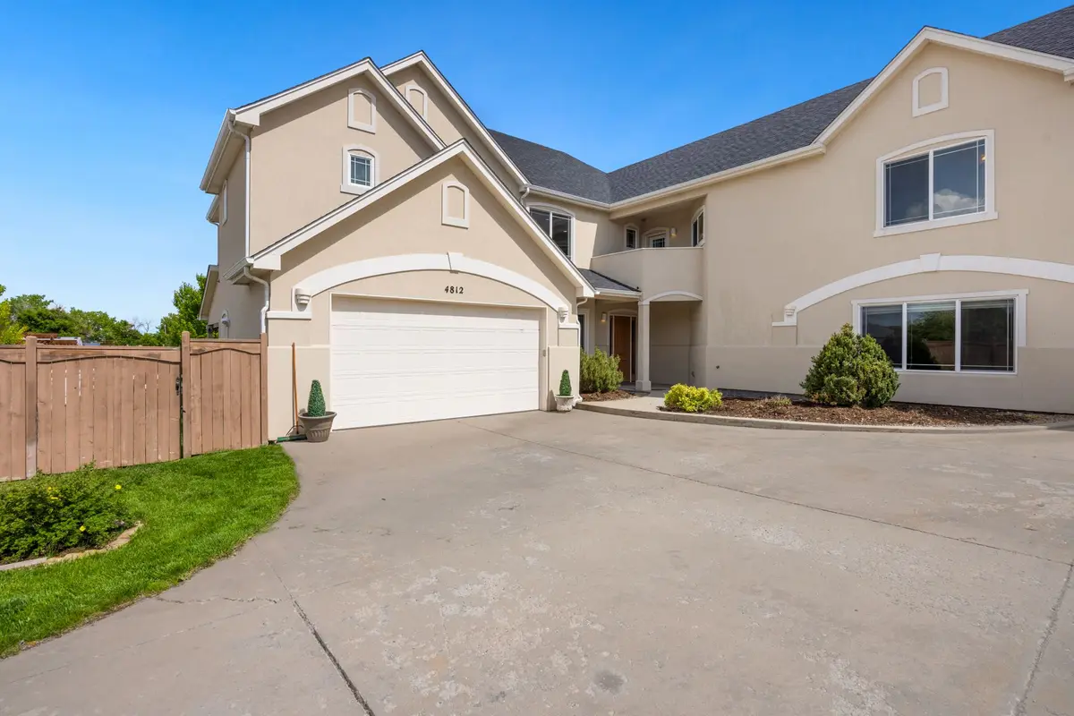 Suburban home with a double garage door and landscaped front yard